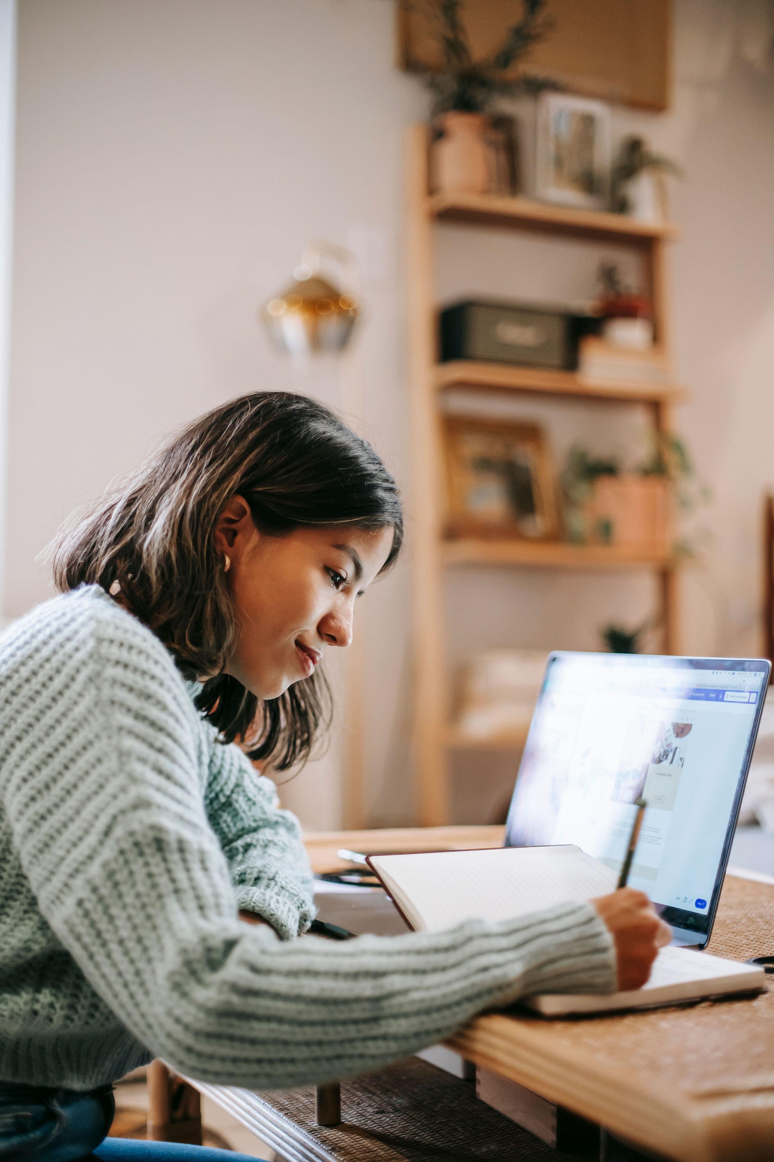 Student studying with laptop and notes for a semester planner